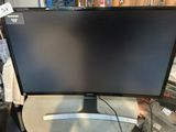 a computer monitor sitting on top of a table next to a keyboard