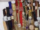 many different types of watches displayed on a wooden plate