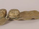 brass figurine of two acorns on a leaf
