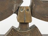 bronze sculpture of a bird on a wooden base with a white background