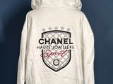 a white hoodie with a chanel logo on it