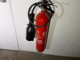 a fire extinguisor attached to a wall next to a door