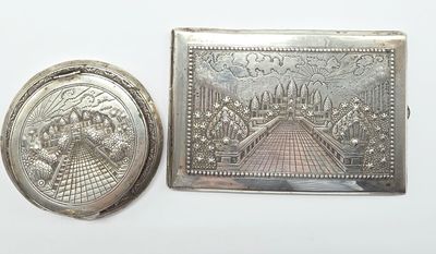 two silver plated objects, one of a woman and one of a man