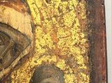 an old wooden icon of a woman holding a child
