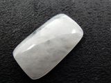 a close up of a white quartz stone on a black surface