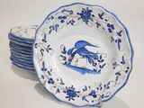 several plates with blue and white designs on them on a white surface