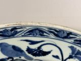 a blue and white plate with a bird on it