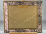 an image of a picture frame on a easel with a rope