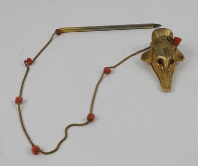 an image of a gold and red beaded necklace with a bird head on it