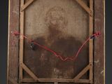 an old wooden easel with a painting on top of it