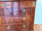 a small chest of drawers on wheels on a hard wood floor