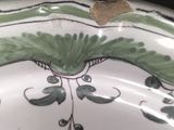 a green and white plate with a design on it