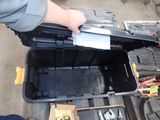 a person holding a tool box with tools inside of it
