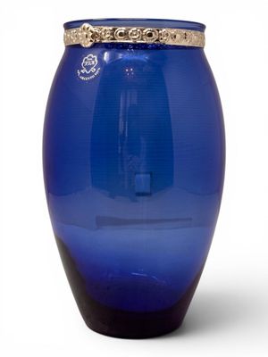 a blue glass vase with a gold rim on a white background