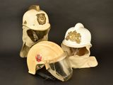 three different types of helmets on display on a black background