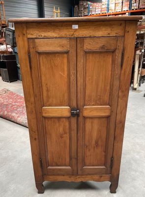 an old wooden armoire with two doors on top of it