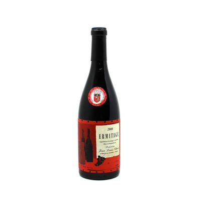 a bottle of wine sitting on top of a white table
