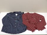 two shirts are sitting on a white table next to each other