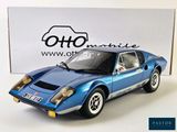 the blue model of a sports car is sitting on a white surface