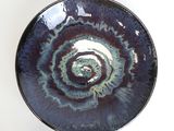 a blue and purple bowl with a spiral design on it