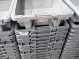 many plastic containers stacked on top of each other on a pallet