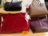 several purses are on a table with price tags on them