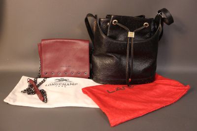 a black purse and a red wallet on a table