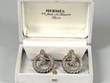 pair of diamond earrings in a box on a white surface