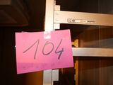 a pink sign that says 1044 hanging on a shelf