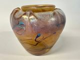 a brown vase with blue designs on it on a white surface