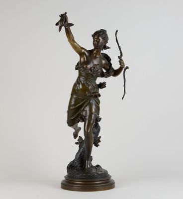 une statue en bronze représentant une femme tenant un arc et une flèche