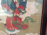painting of a man in a red robe holding a snake in his right hand