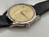 a close up of a watch on a white surface