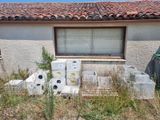 a house that has a lot of appliances outside of it