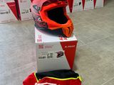 a helmet on the ground next to boxes of boxes
