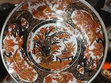a person that is holding a plate with a design on it
