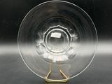 a clear glass with a gold handle on a table