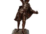 bronze statue of a man holding a bird on a marble base