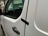 a white truck parked in a garage with its door open