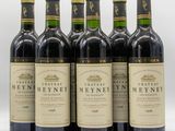 six bottles of wine are lined up on a white surface