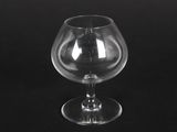 an empty wine glass sitting on top of a black table
