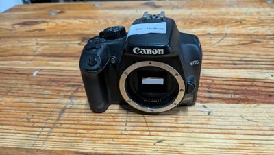 a canon camera sitting on a wooden table