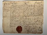 un gros plan sur un morceau de papier portant un cachet de cire