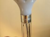 a hand that is holding a light that is on a table