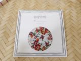an image of a book with a picture of a flowered plate on it
