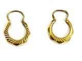 two pairs of gold earrings on a white surface with a white background