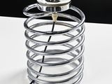 a silver lamp that is sitting on a white table