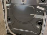 an open door of a silver dishwasher sitting on top of a floor