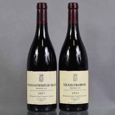 two bottles of wine sitting on top of a table next to each other