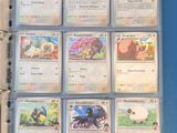pokemon trading cards in a binder on a blue surface